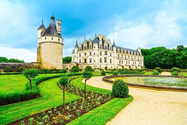 Visitors in the gardens of Chateau de Chenonceau on a small-group Loire Valley castles tour from Paris